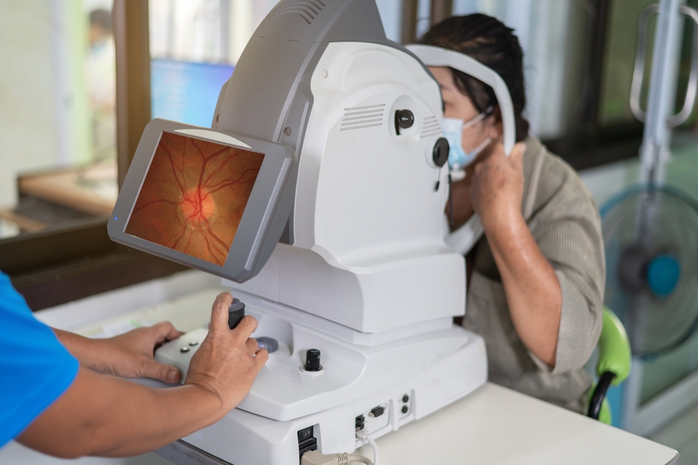 Doctor examines his patient's retina with imaging technology to check for RVO.